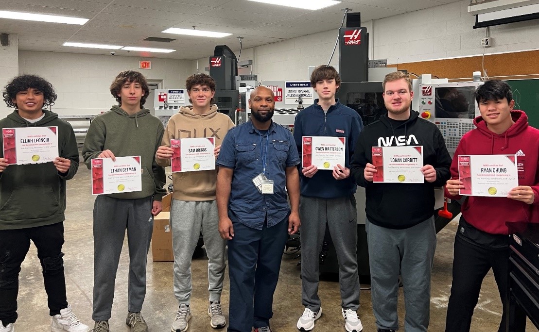 Pictured with instructor Antonio Hayes ( middle) are students from one of his NIMS classes at Arlington High School. .