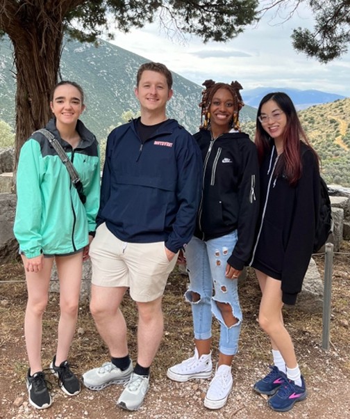 Mythology students stop for a photo op at the shrine of Apollo, in Delphi, Greece, which they visited as part of a TnCIS study abroad program.