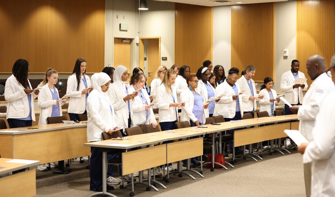 Nursing students recite the Nightingale Pledge at a White Coat Ceremony on Nov. 22, 2024.