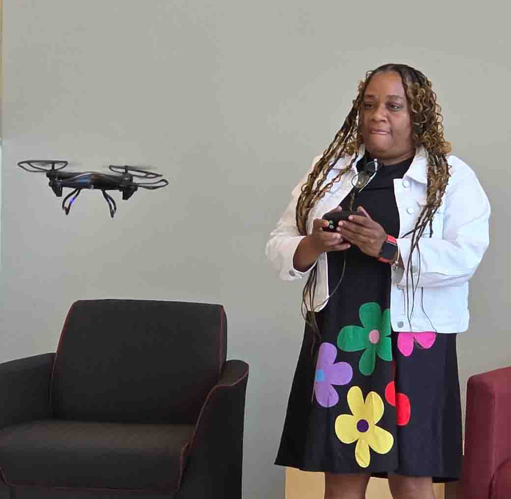 Students posing with a drone