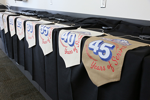 employee with flag showing years of service