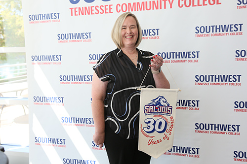 employee with flag showing years of service