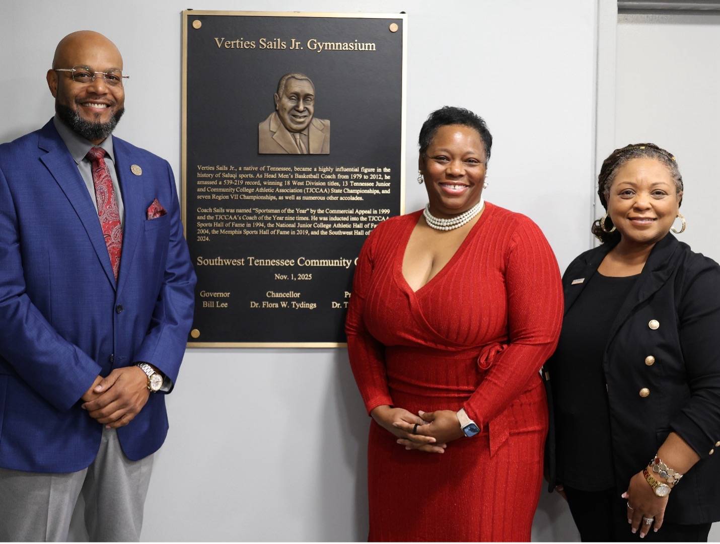Coach Jarrett Stephen, Francesca Sails, and Dr. Tracy D. Hall honor Coach Verties Sails Jr. during a plaque dedication ceremony located in the gymnasium that bears his name. 