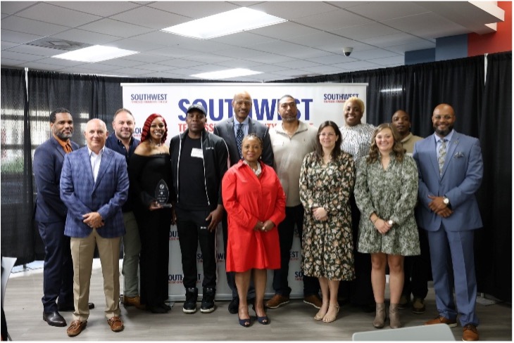 Dr. Hall posing with a dozen SWTCC retirees