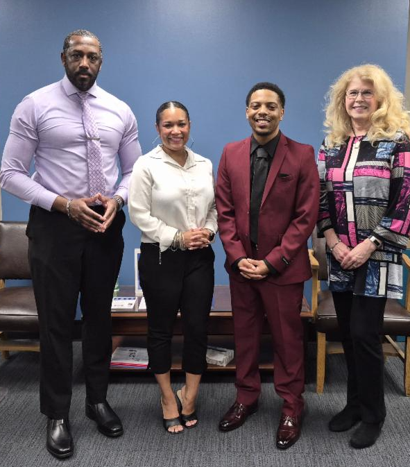 Southwest student Ladarrius Ward (in suit) poses with Advising and Career Services Specialists Courtney Ward, Jhonna Gipson and Manager Brenda Williams.