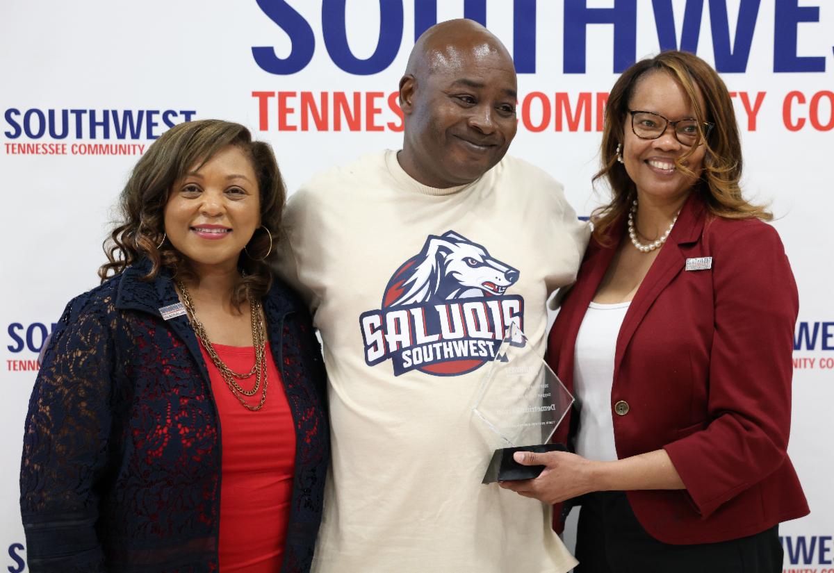 Demetrius Parson (center) was presented the Support Staff of the Year Award by (L) President Tracy D. Hall and (R) Tameka Perry, chief of staff.